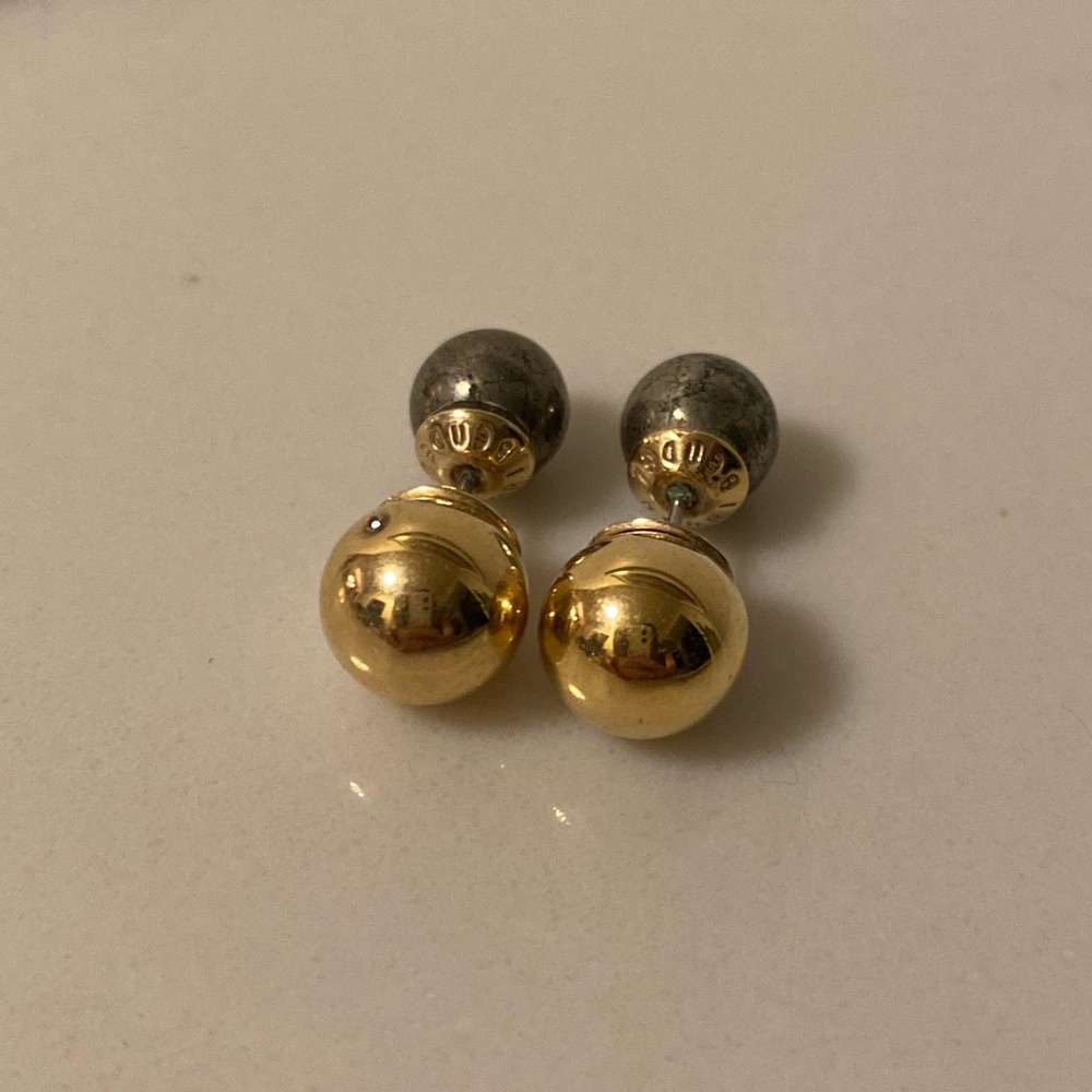 Henri Bendel two-sided ball costume earrings in gold and chrome.